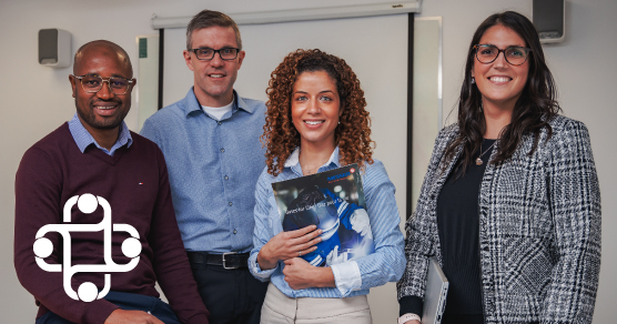 photo of four people in a business setting